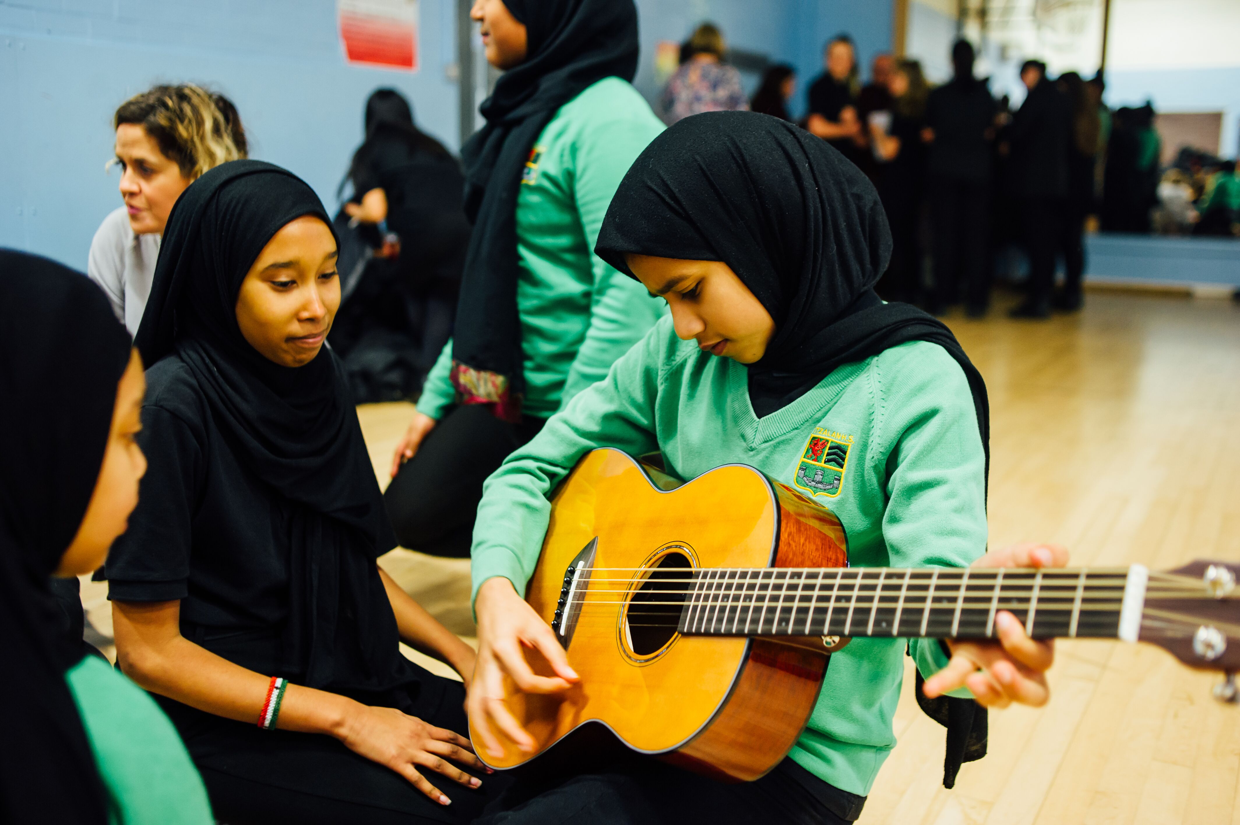 Child playing guitar at Fitzalan High School 