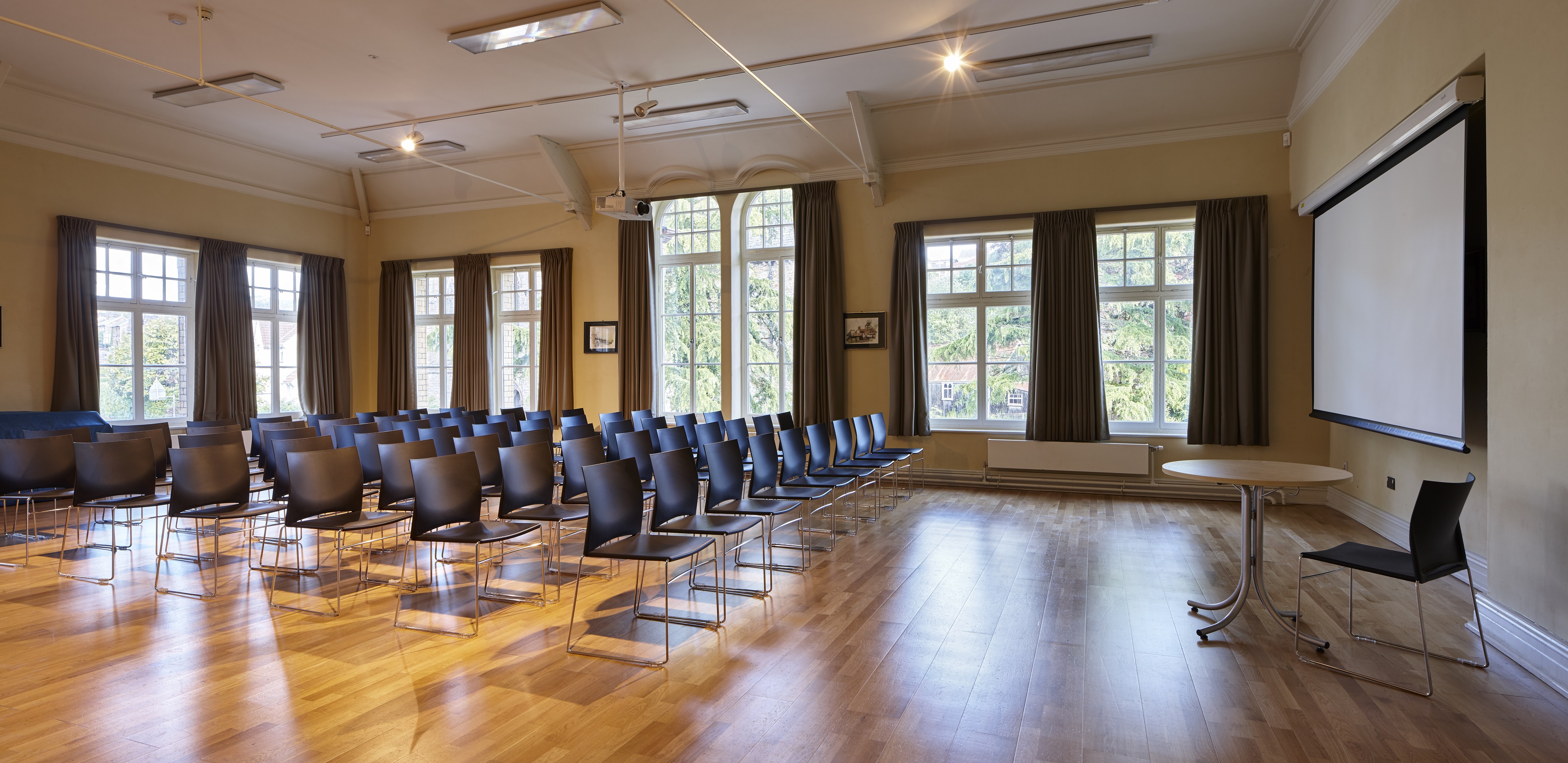 Function room interior set up theatre style with projector