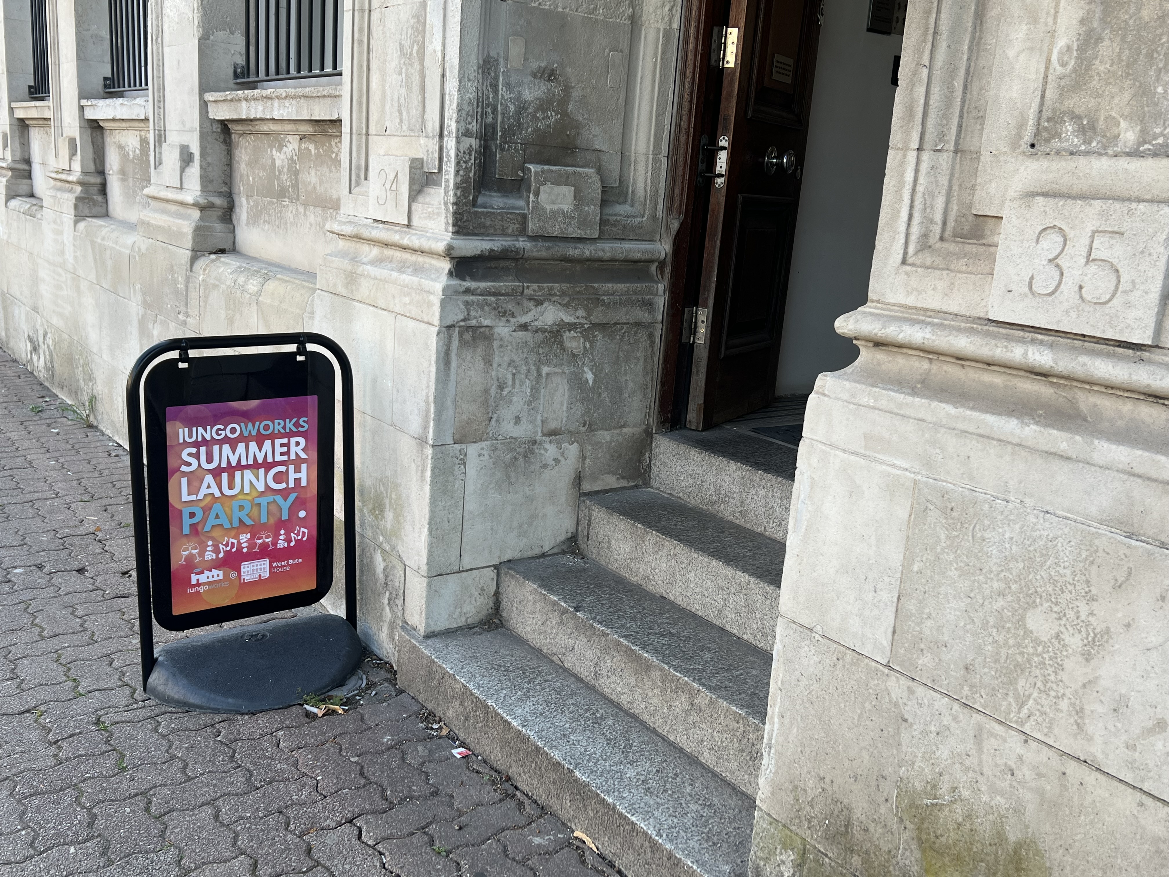 An image of the Entrance to West Bute House with an A Board displaying an advertisement for the iungoworks Summer Launch Party