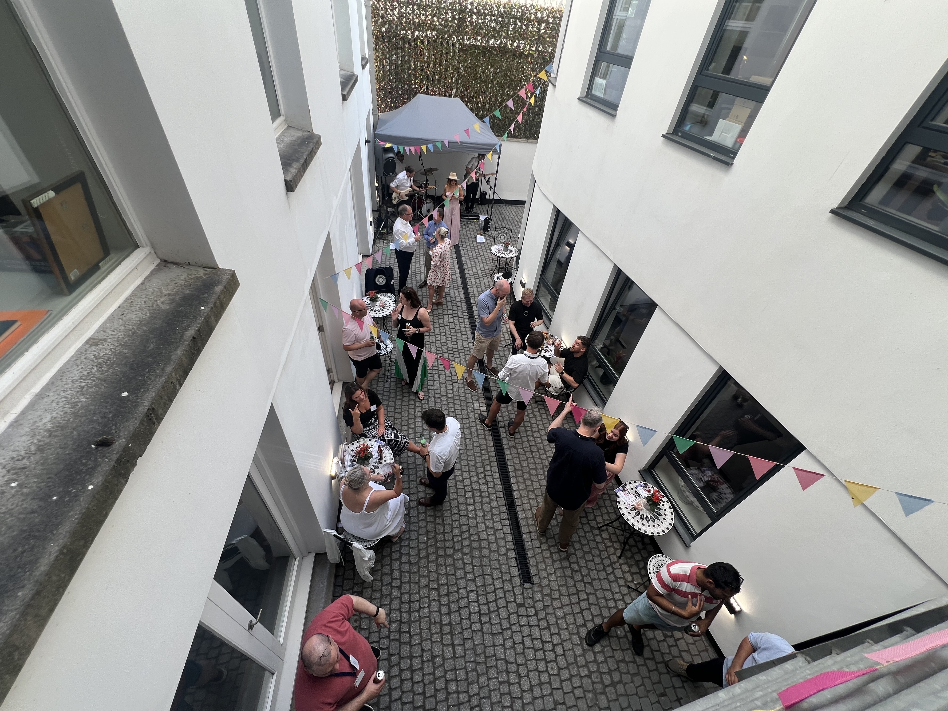 An image taken from an aerial view of a party taking place in the Courtyard of West Bute House