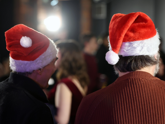 An image of attendees at last year's festive party with santa hats