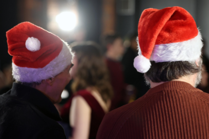 An image of attendees at last year's festive party with santa hats